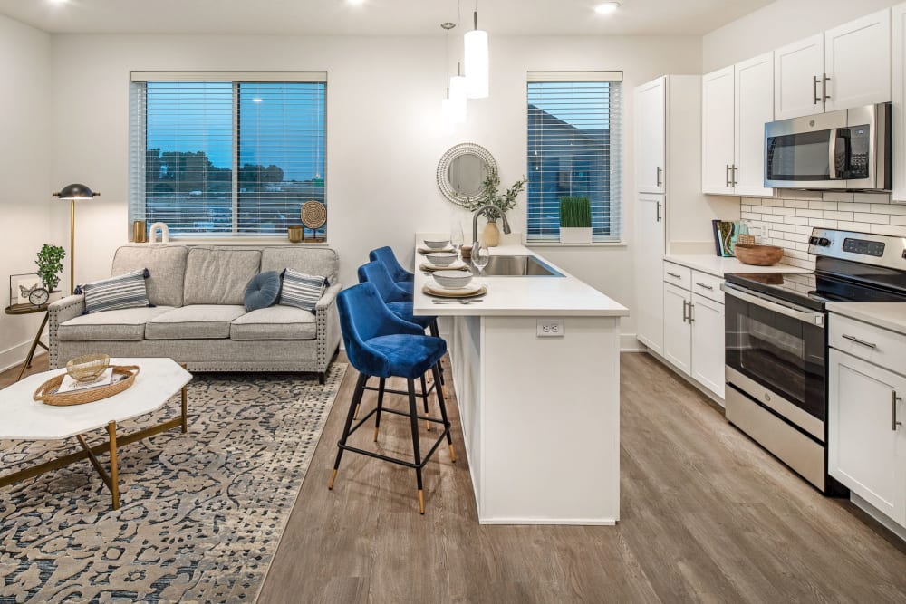 Wide view of a living room, dining, and a open kitchen at Ravello 192 in Elkhorn, Nebraska