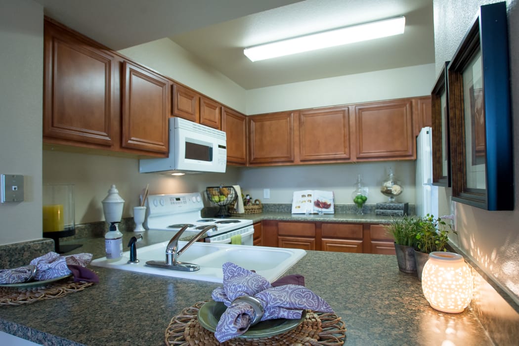 Kitchen with white appliances at Villas at Stonebridge in Edmond, Oklahoma