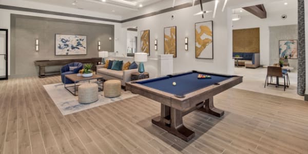 Clubhouse lounge and pool table at Murano at Three Oaks in Fort Myers, Florida