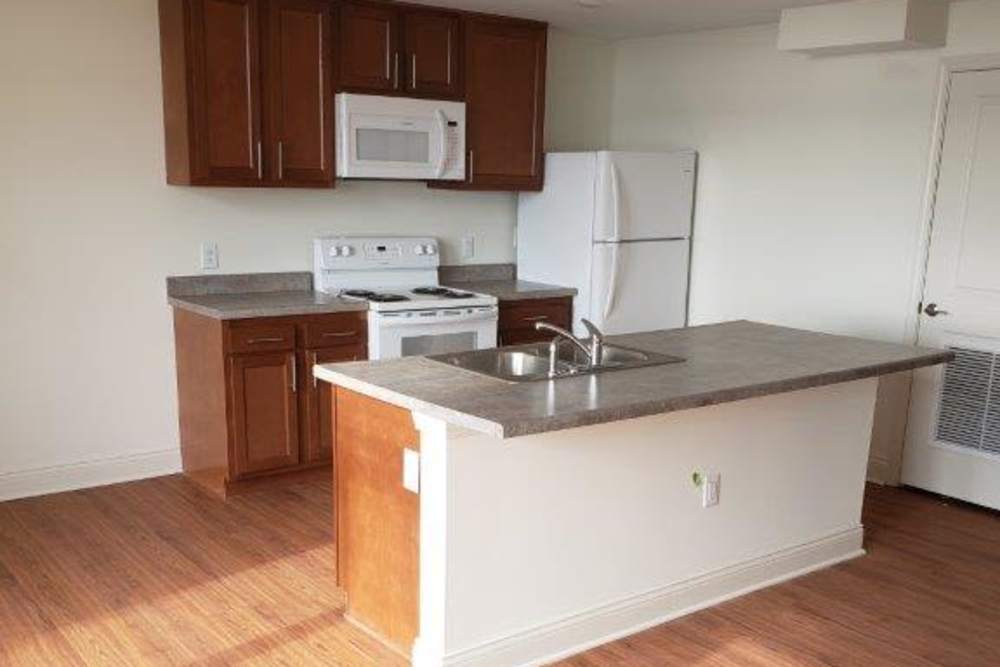 Modern kitchen with granite countertops and stainless steel appliances at 43 Town Square in Lima, Ohio