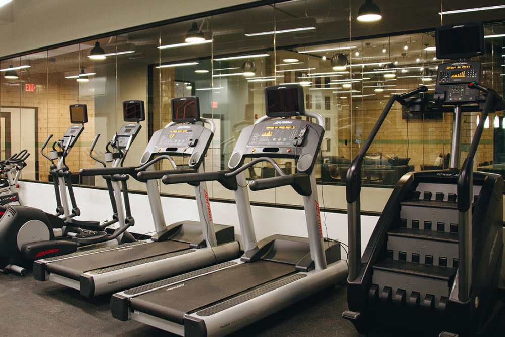 Modern fitness center with cardio equipment at Courtyard Lofts at Scott’s Addition in Richmond, Virginia