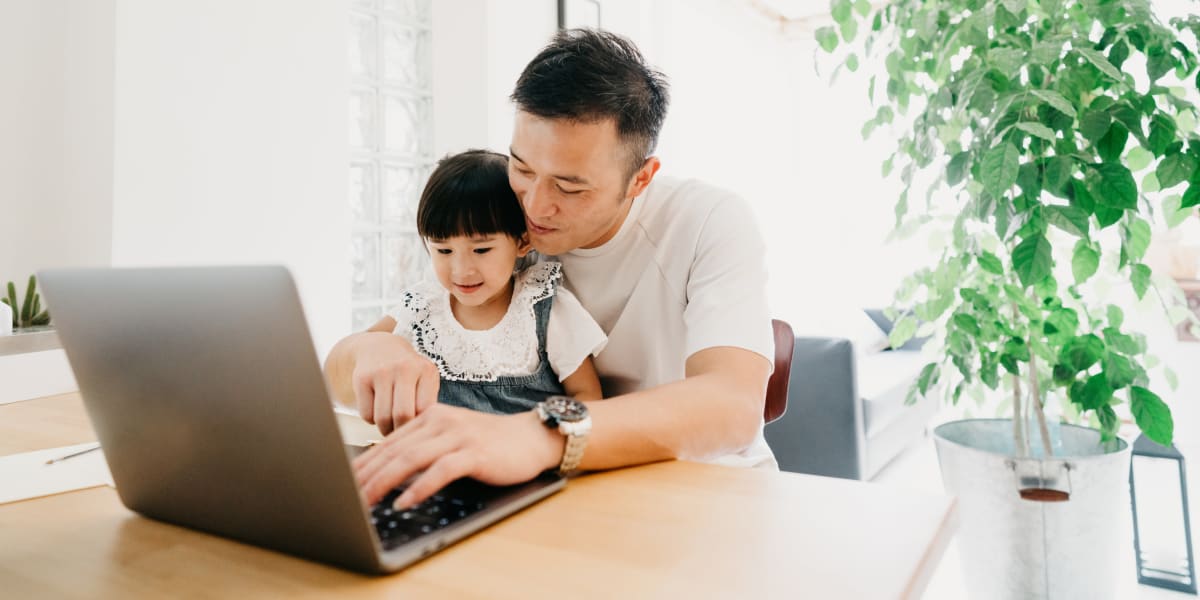 Resident working on computer his daughter at Marquis at Lantana in Flower Mound, Texas