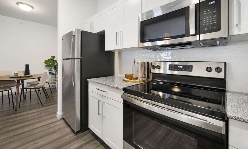 Apartment kitchen with white cabient at The Warrick in Nashville, Tennessee