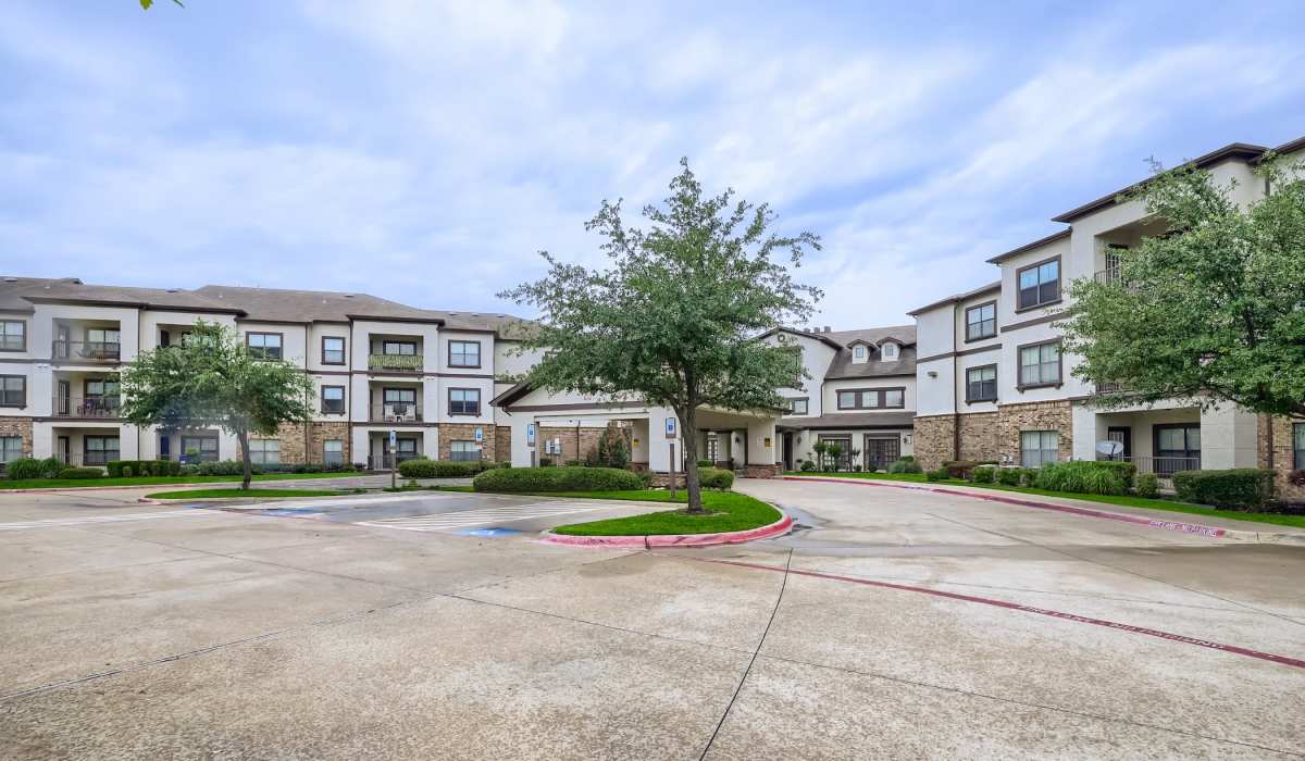 Modern apartment community with landscaped grounds and a welcoming entrance at Lindbergh Parc Senior Apartments in Fort Worth, Texas