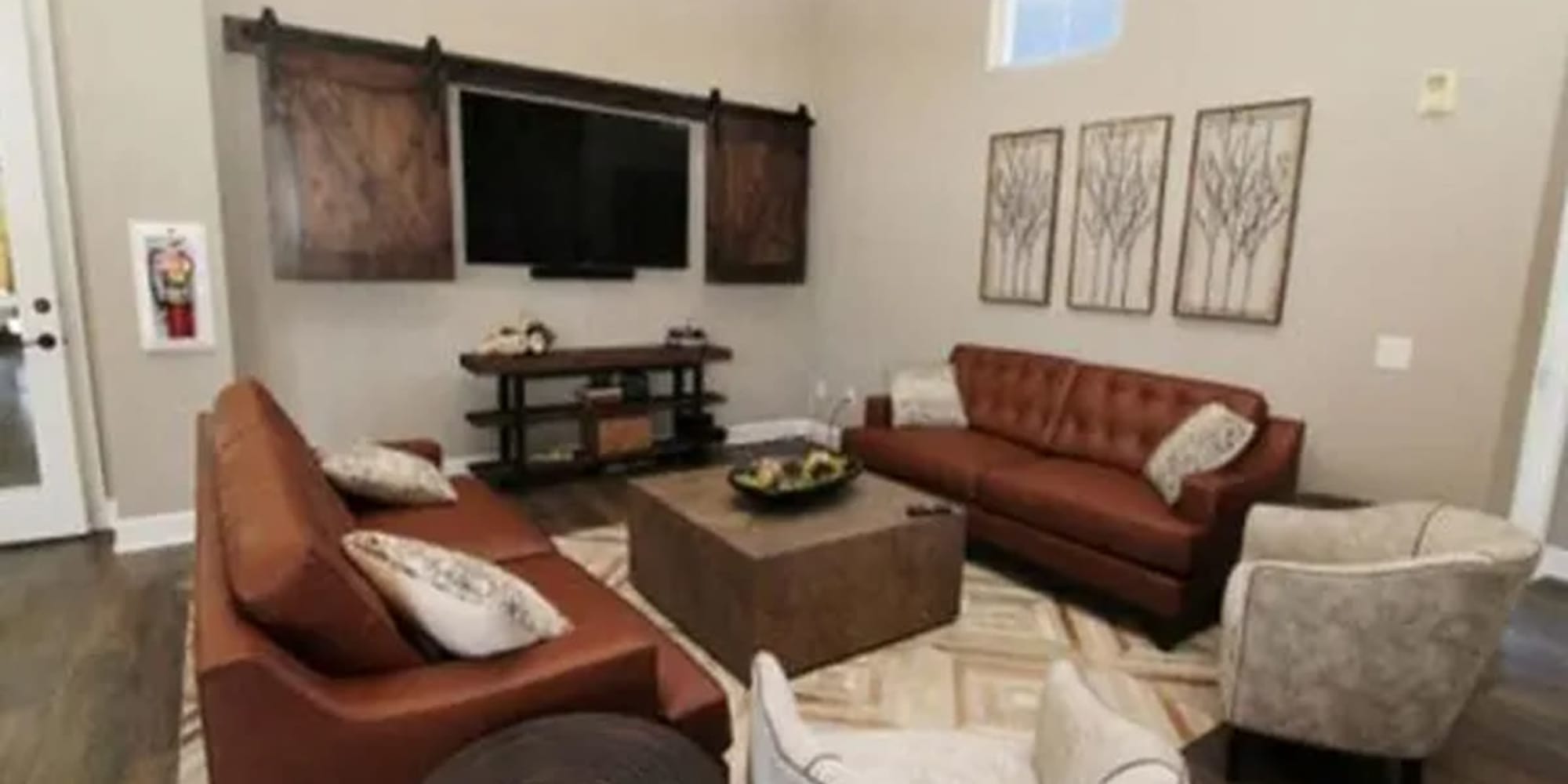 Clubhouse seating and TV at  Siena Villas Apartments in Elk Grove, California