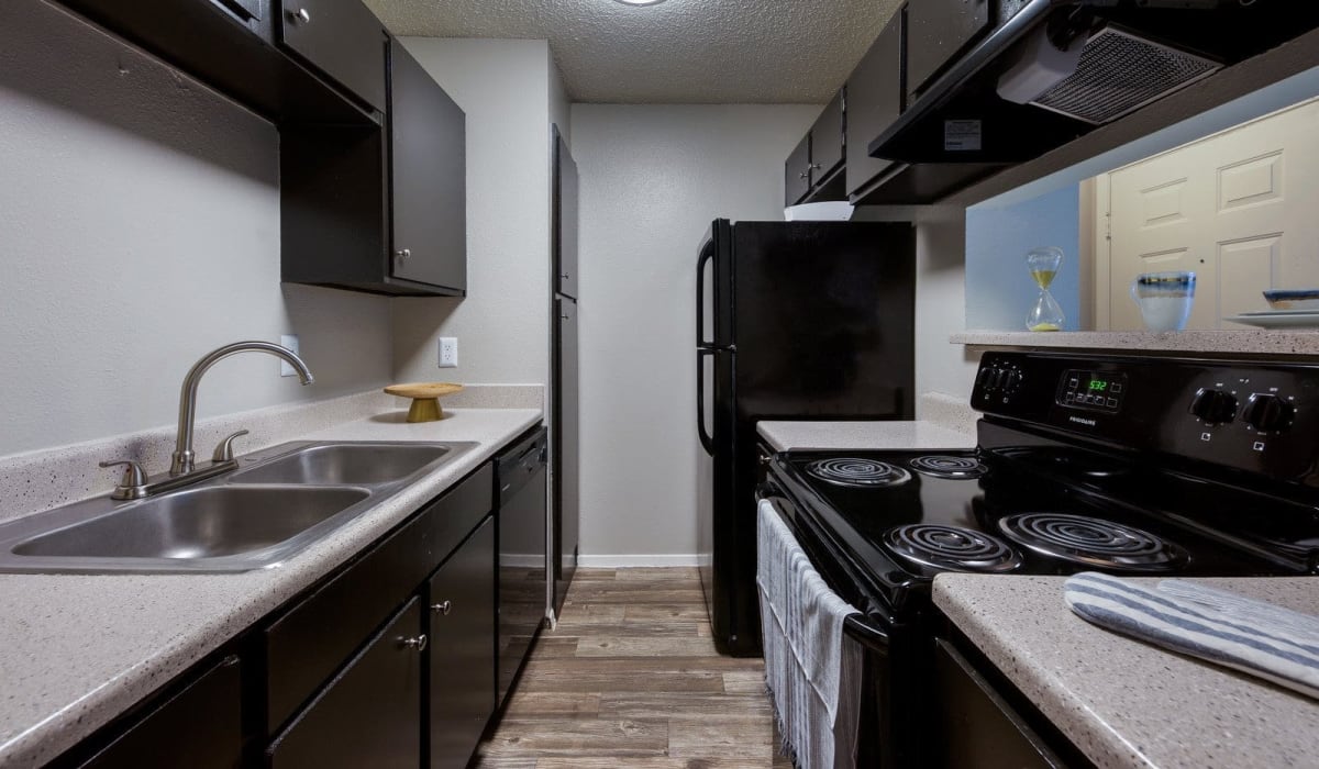 Black appliance kitchen at Holbrook Apartment Homes in Dallas, Texas