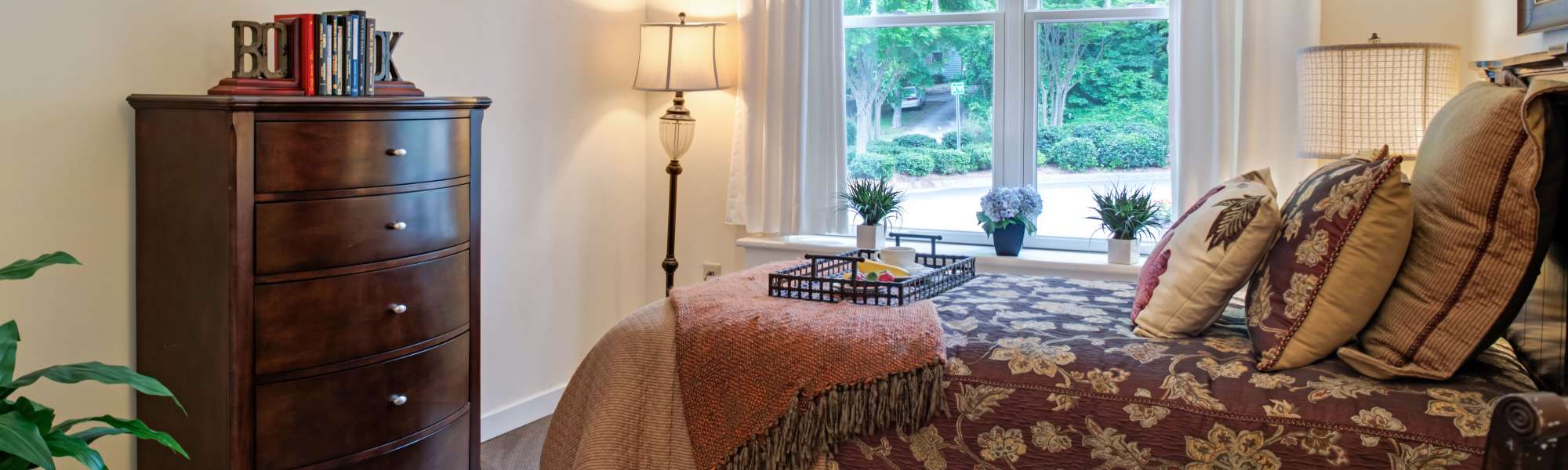 Spacious bedroom with large window and storage unit at Glenncrest at Buckhead in Atlanta, Georgia