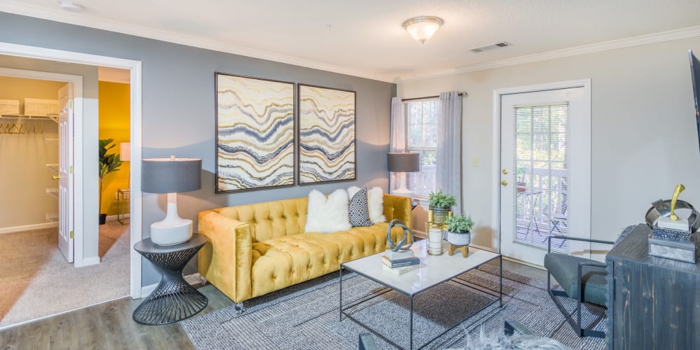 Open concept floor plan with hardwood floors and modern decor at The Oxford in Conyers, Georgia