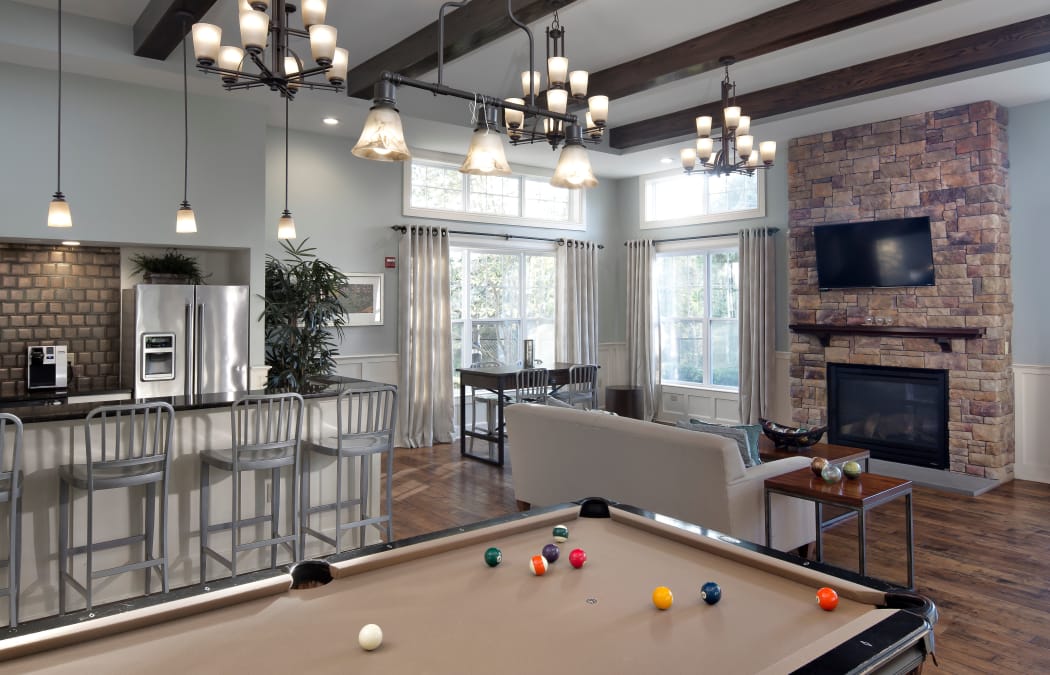 Billiards table and hardwood floors in beautifully decorated resident clubhouse at Prynne Hills in Canton, MA