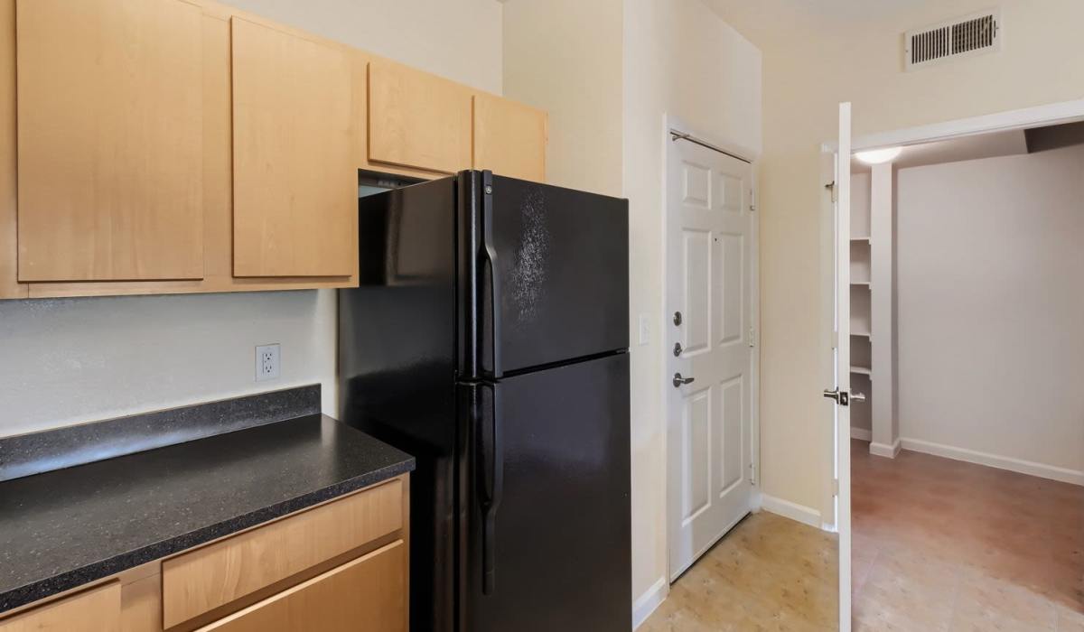 Entryway featuring a black refrigerator and light-colored walls with tile flooring at Lindbergh Parc Senior Apartments in Fort Worth, Texas