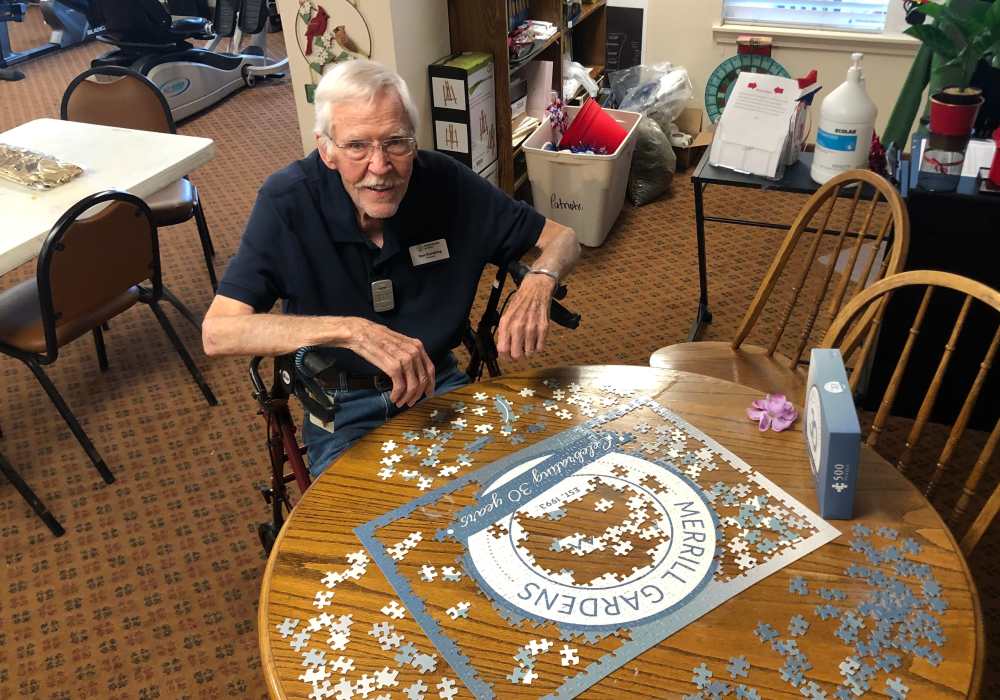 Resident building a puzzle at Truewood by Merrill, Roseville in Roseville, California