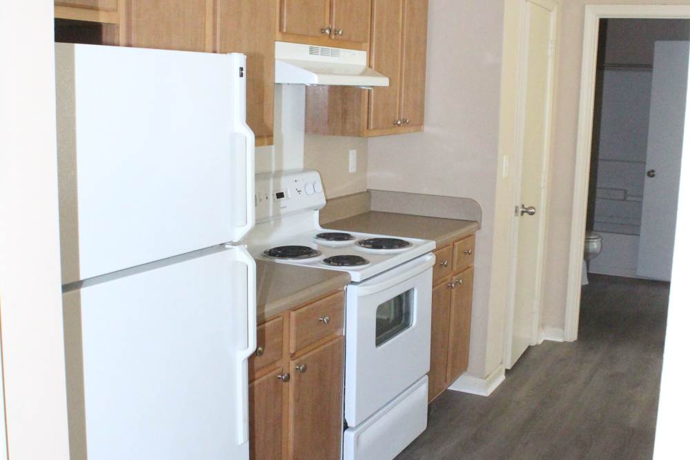 Kitchen with wooden cabinets at Lexington Park in Ocean Springs,Mississippi