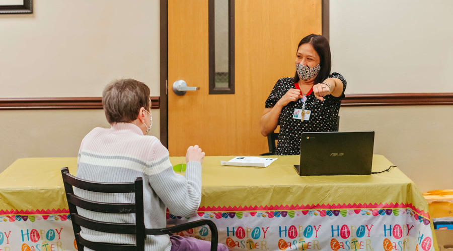 Resident and caretaker talking with each other at Cascade Park Adult Day Health in Tacoma, Washington