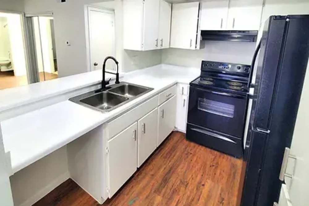 Kitchen with hardwood flooring at Arcos in San Antonio, Texas