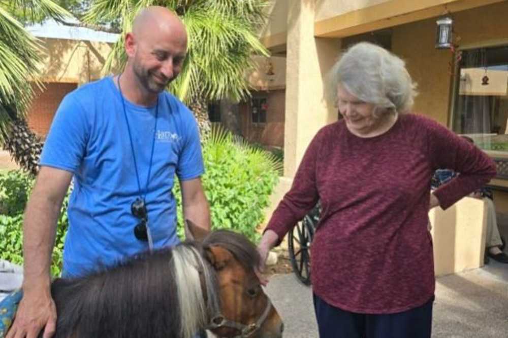 Old lady with a horse at Woodland Palms Memory Care in Tucson, Arizona