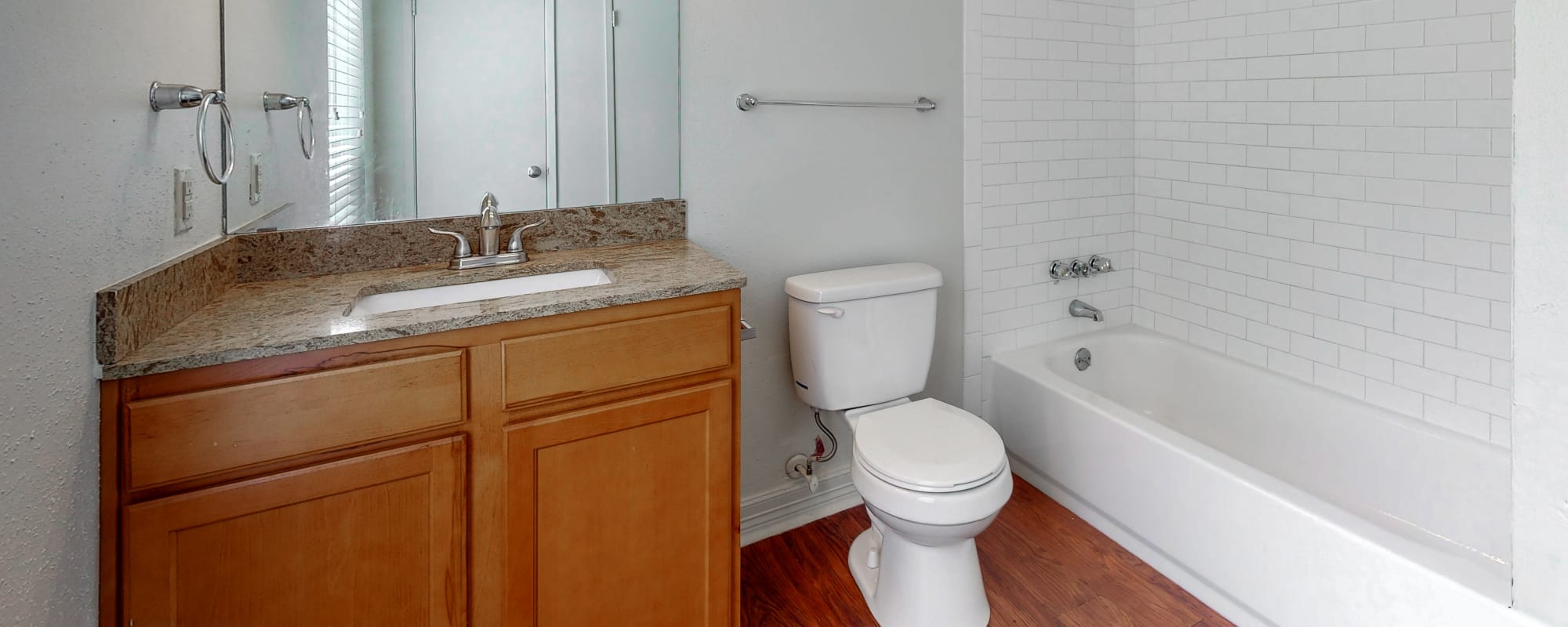 Bathroom with vanity lights at Millbrook Apartments in Shreveport, Louisiana