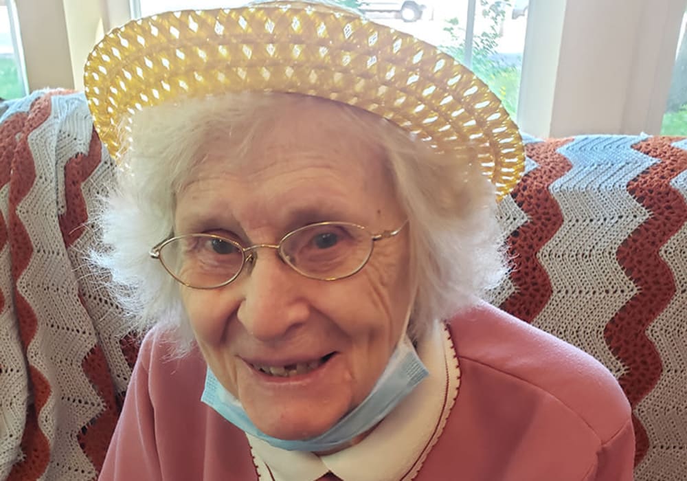 Happy resident relaxing in the sun room at The Residences on Forest Lane in Montello, Wisconsin