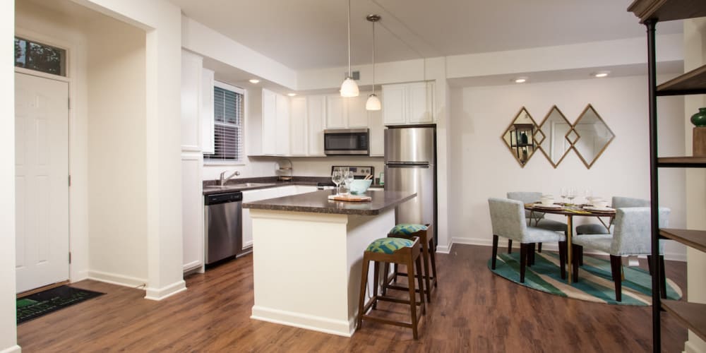 An apartment kitchen with an island at Cottages at Emerald Cove in Savannah, Georgia