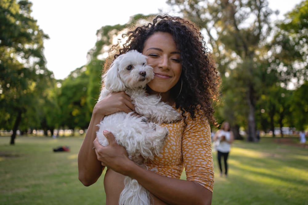 Resident smiling  with puppy at  Emma Jean Hull Flats in Benton Harbor, Michigan