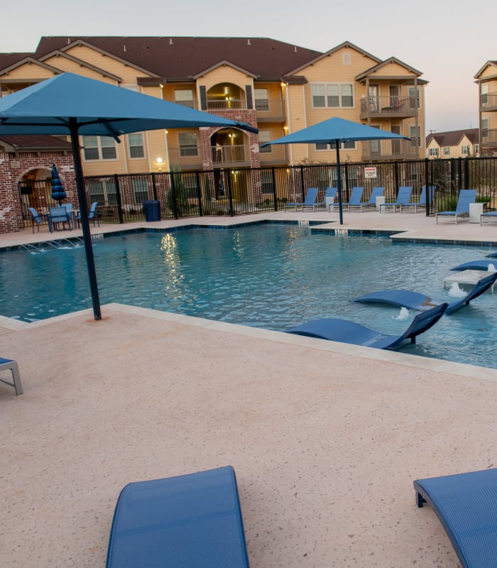 Sparkling pool and sundeck outside of Portico at Friars Creek Apartments in Temple, Texas