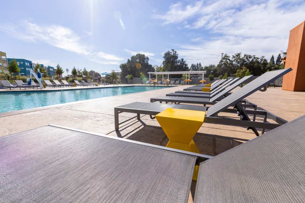 Swimming pool with in-pool loungers at Solasta in Sacramento, California