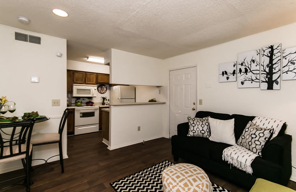 Spacious living room and dining area with wood-style flooring and pass-through to the kitchen at The Waterford Apartments in Columbia, South Carolina