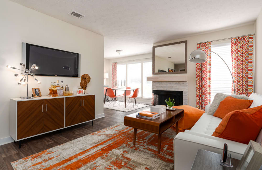 Living room with a fireplace and wood-style flooring at The Hundred Exchange in Fayetteville, Georgia