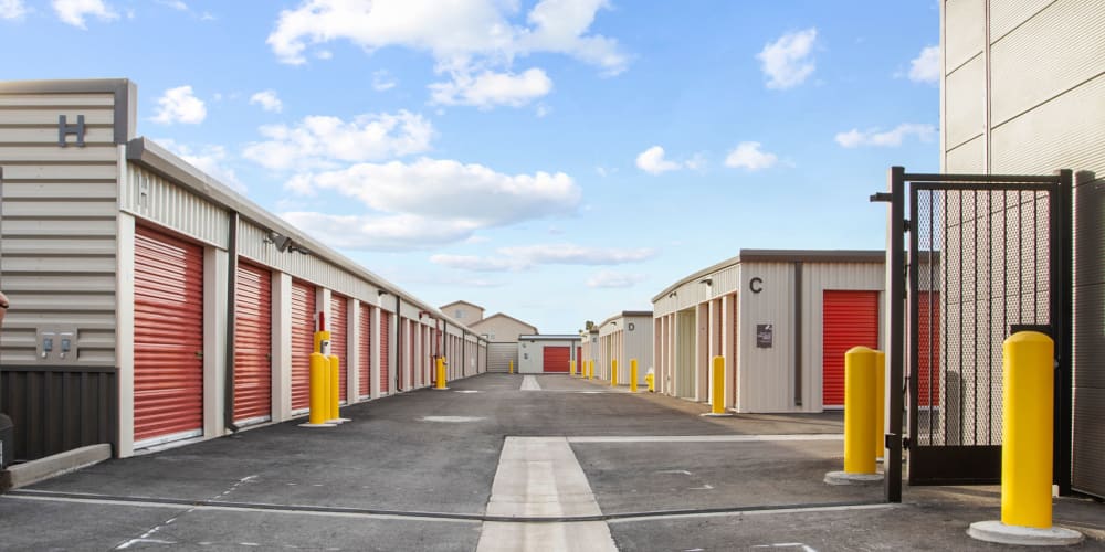 Outdoor storage units with a wide driveway at StorQuest Express Self Service Storage in Phoenix, Arizona