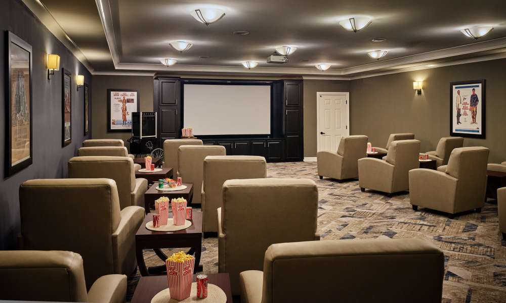 Private theater room with recliner-style seating at Waltonwood Cotswold in Charlotte, North Carolina  