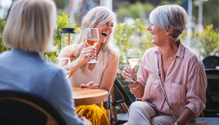 Residents dining together outside of The Springs at Lake Oswego in Lake Oswego, Oregon