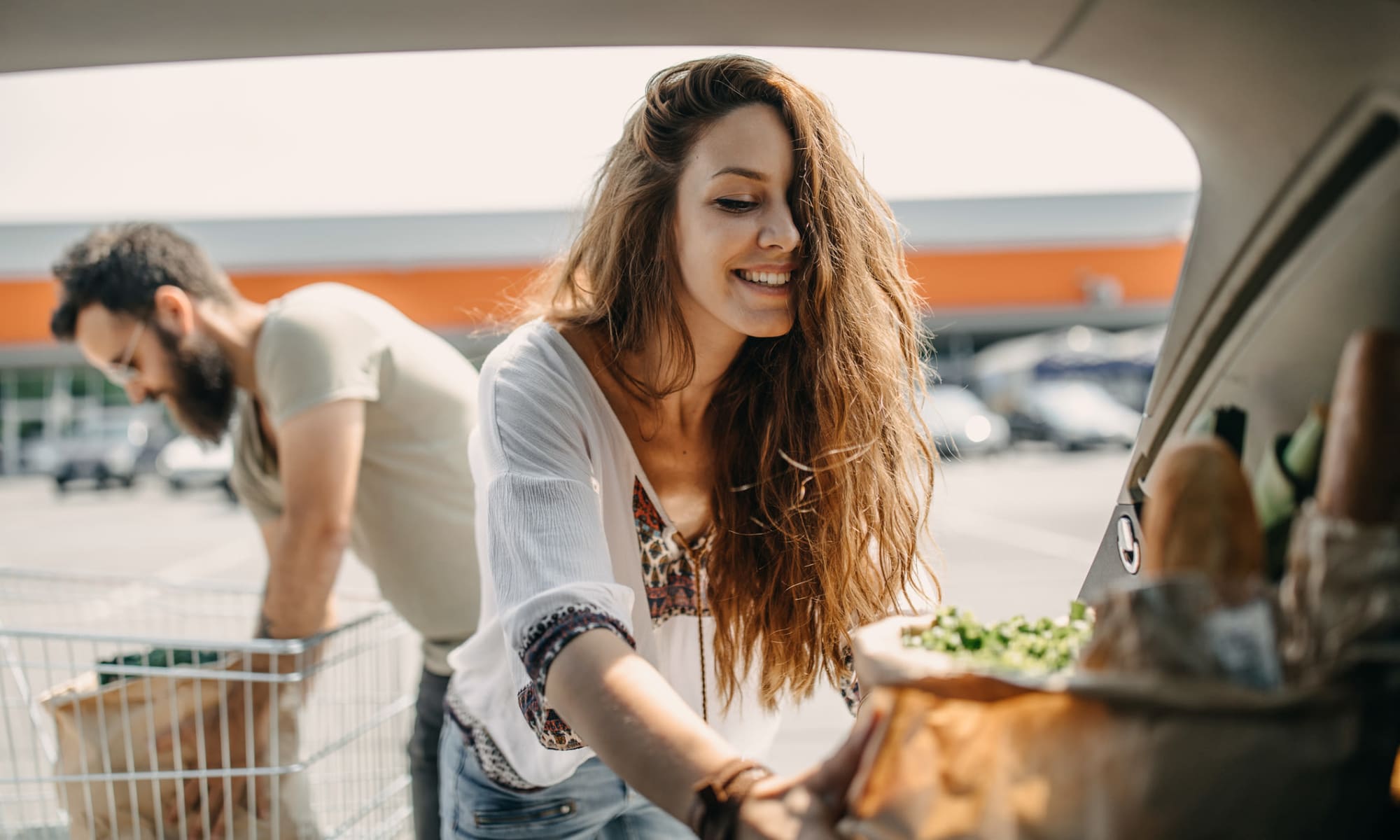 Resident couple loading groceries into their car after shopping downtown near The Meadows in Culver City, California