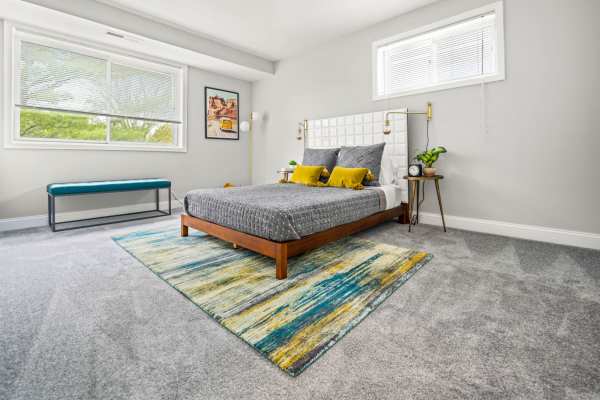 Spacious bedroom decorated in calm, neutral tones at Beacon Hill Apartments in Alexandria, Virginia