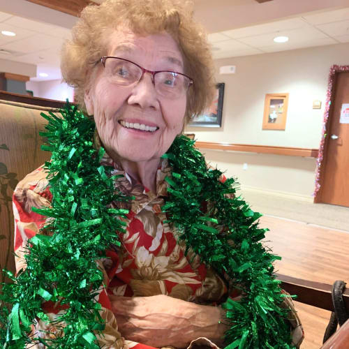 resident wearing a festive wreath at The Oxford Grand Assisted Living & Memory Care in Wichita, Kansas