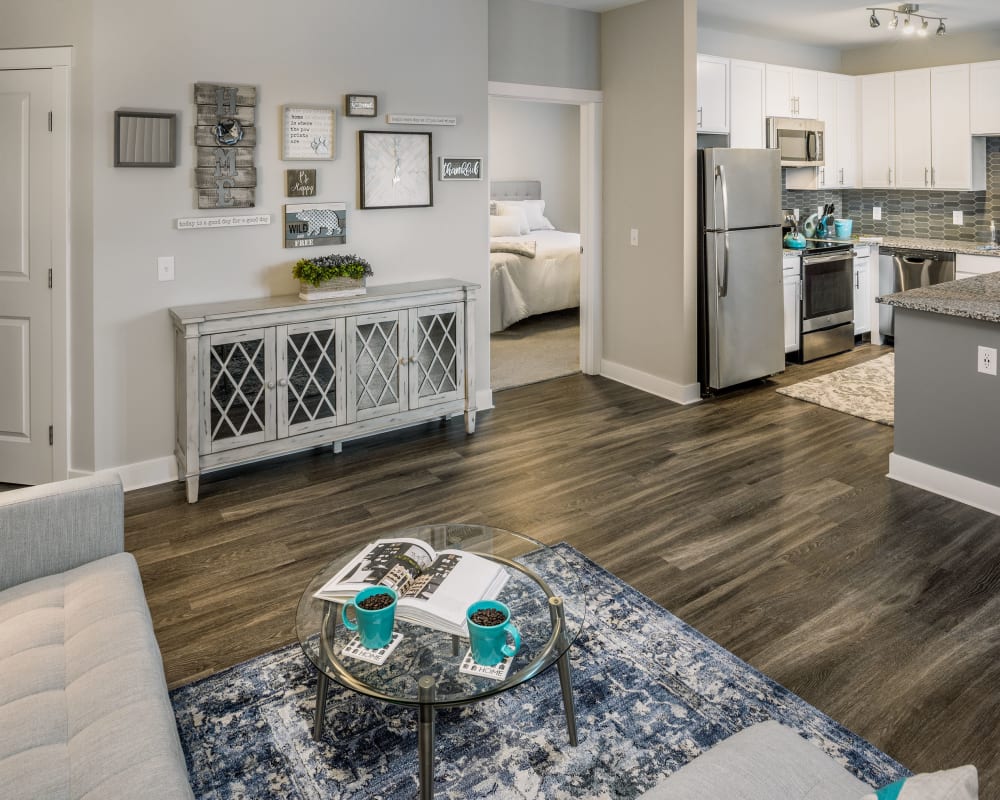 Spacious living room with woo style flooring at The Beacon at Gateway in Scarborough, Maine