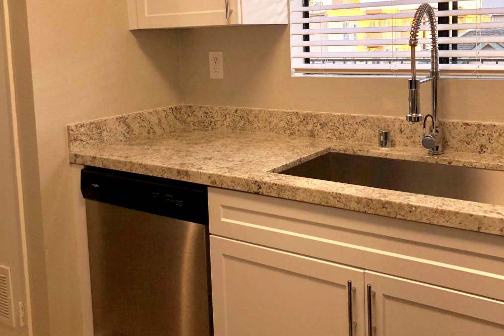 Kitchen sink with granite countertop at The Indie Glendale Collection in Glendale, California
