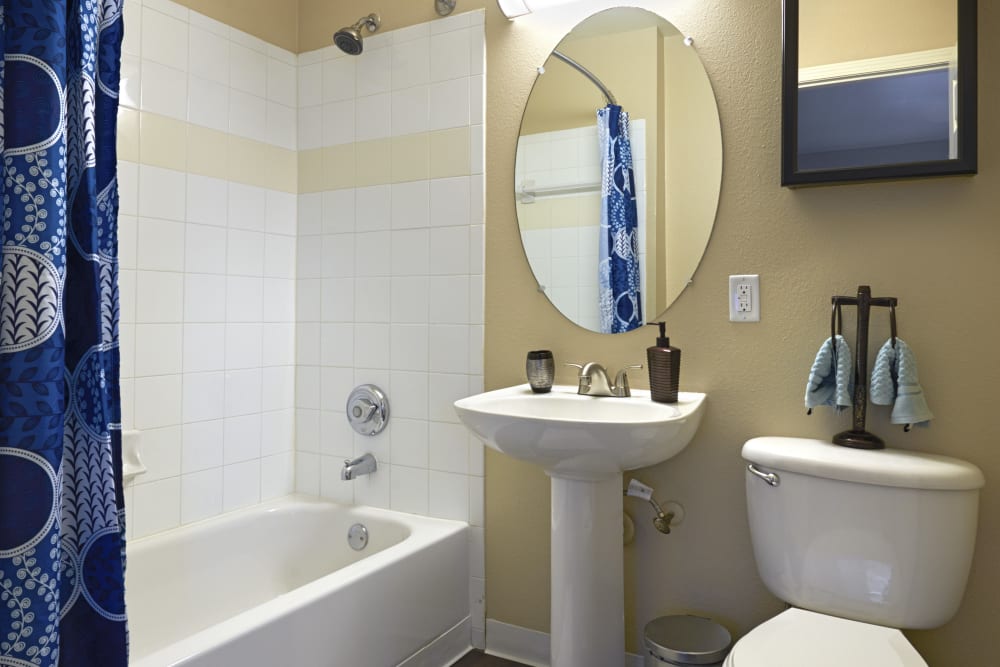 Bathroom with pedestal sink at Crossroads at City Center Apartments in Aurora, Colorado