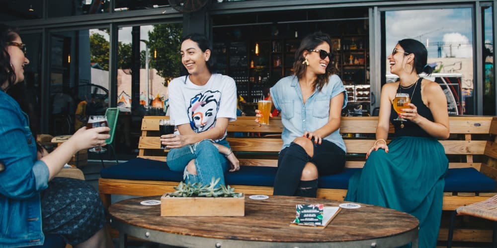 Friends drinking beer at a trendy spot near Bon Aire Apartments in Castro Valley, California