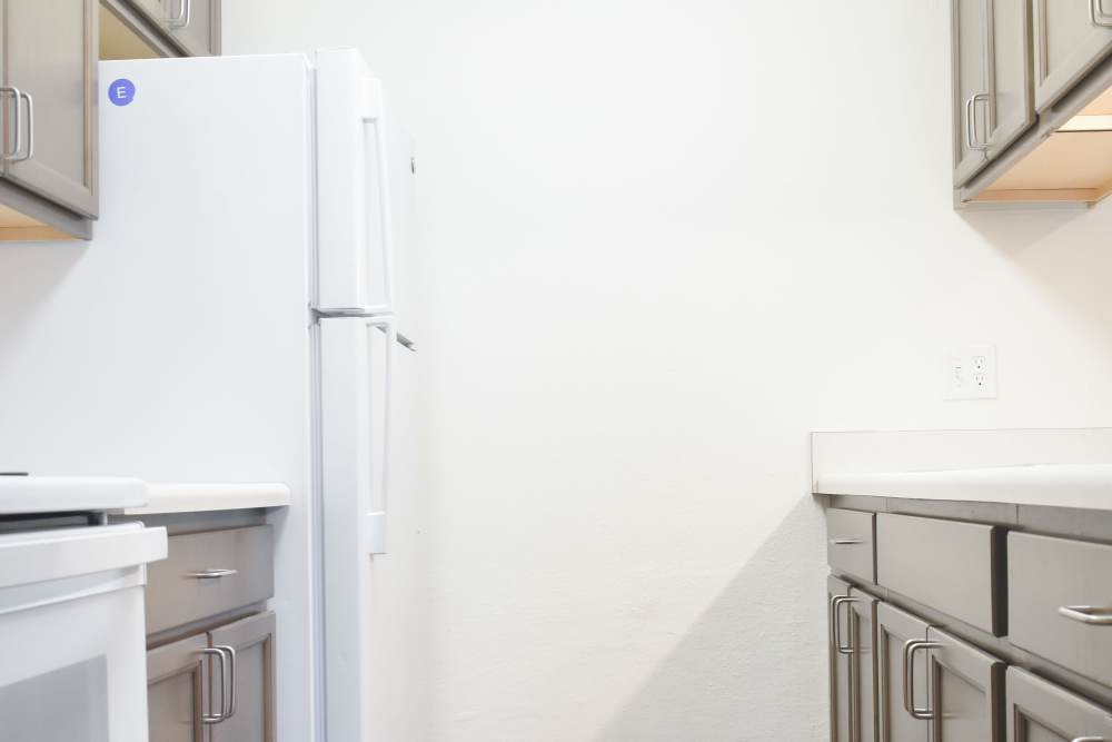 Modern kitchen with appliances and wooden cabinetry at Clairewood Apartments in Saint Clair, Michigan