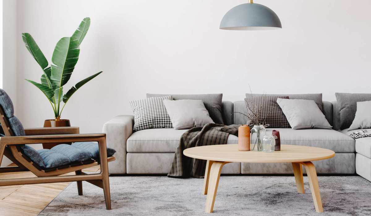 Charming living room with a cozy sofa, stylish decor, and lush greenery at Lake Pointe Apartments in Madison, Wisconsin.