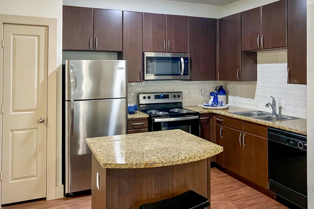 Kitchen with wood-style flooring at Broadstone Grand Avenue in Pflugerville, Texas