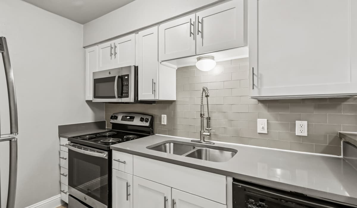 Kitchen with range and wooden cabinets at Aberdeen at Bellmar in Dallas, Texas 