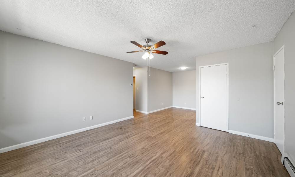 Spacious living room with ceiling fan and window at The Meadows in Sparks, Nevada