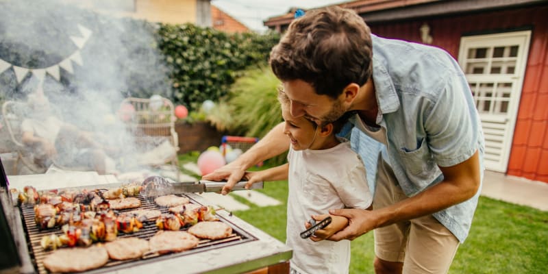 A father and son cooking at a grill at a home at Coleville in Coleville, California