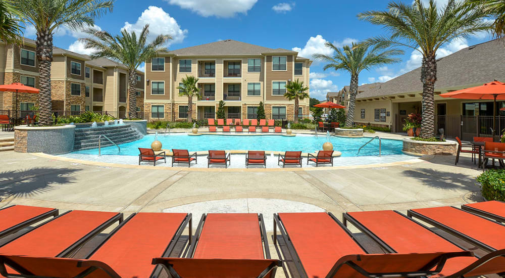 Lounge chairs and sundeck by the stunning resort-style pool at Haven at Eldridge in Houston, Texas