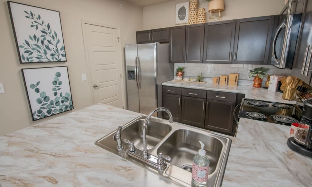 Fully equipped kitchen with granite countertops at Redbud Ranch Apartments in Broken Arrow, Oklahoma