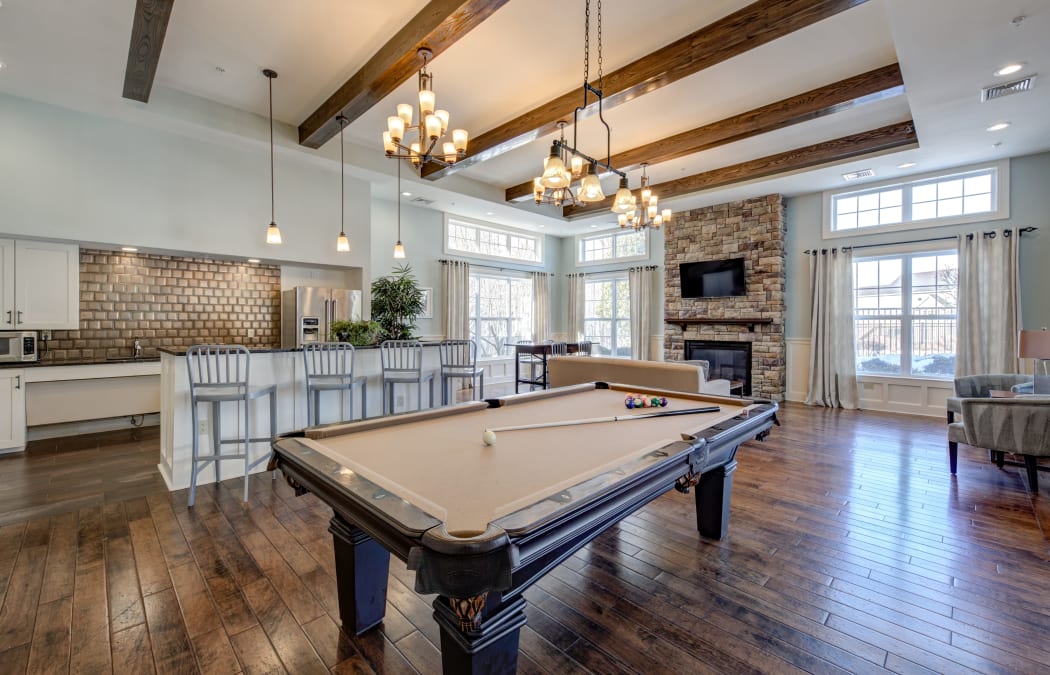 Billiards table and hardwood floors in beautifully decorated resident clubhouse at Prynne Hills in Canton, MA