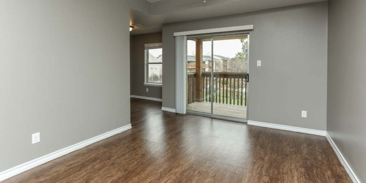Unfurnished living room with attached patio at Palatia Apartment Homes in San Antonio, Texas