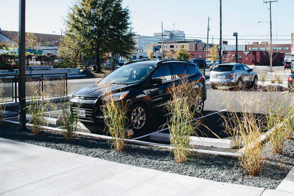 Parking area with landscaped greenery at Courtyard Lofts at Scott’s Addition in Richmond, Virginia