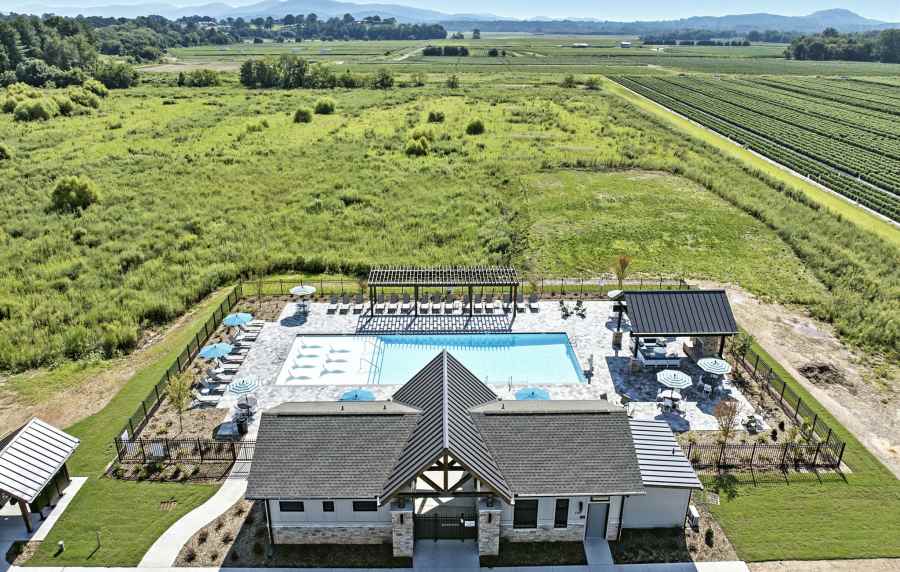 Aerial view of clubhouse and pool and surrounding land at Artisan Living Mills River in Mills River, North Carolina