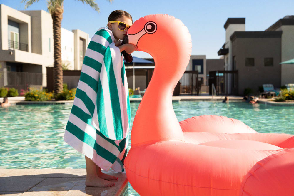 A girl with an inflatable flamingo by the pool at BB Living at Civic Square in Goodyear, Arizona